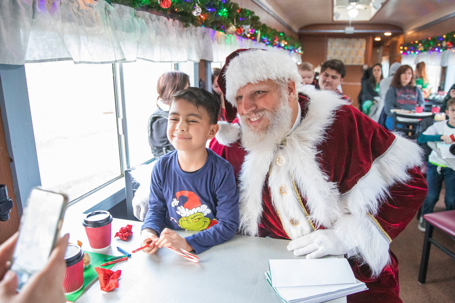 Pictures are taken as Santa visits kids at the Steam Train Depot in Chehalis on Saturday.