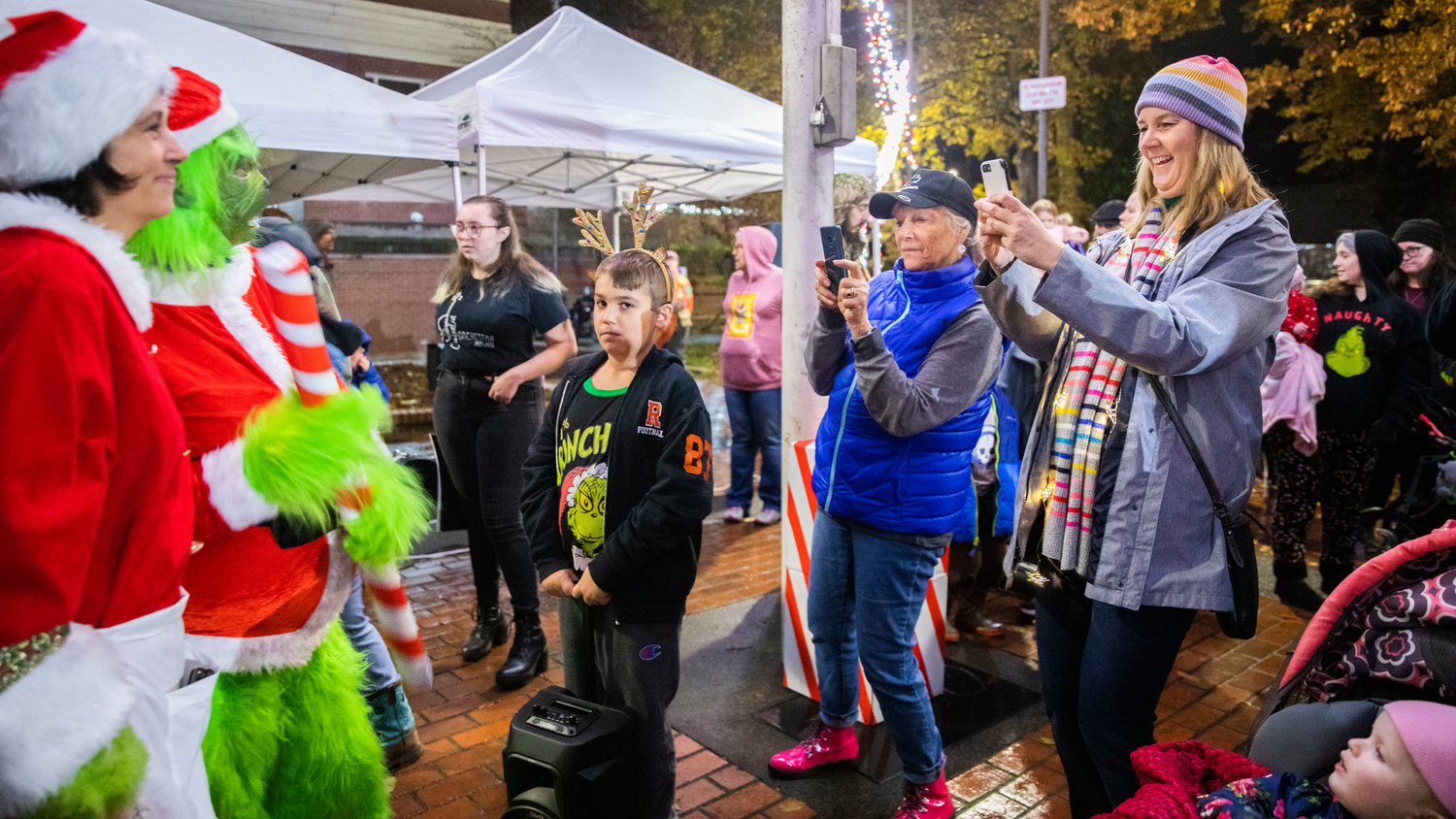 Mayor Kelly Smith Johnston smiles while taking photos of the Grinch and Cindy Lou Who at George Washington Park during a Christmas Tree Lighting celebration on Friday.