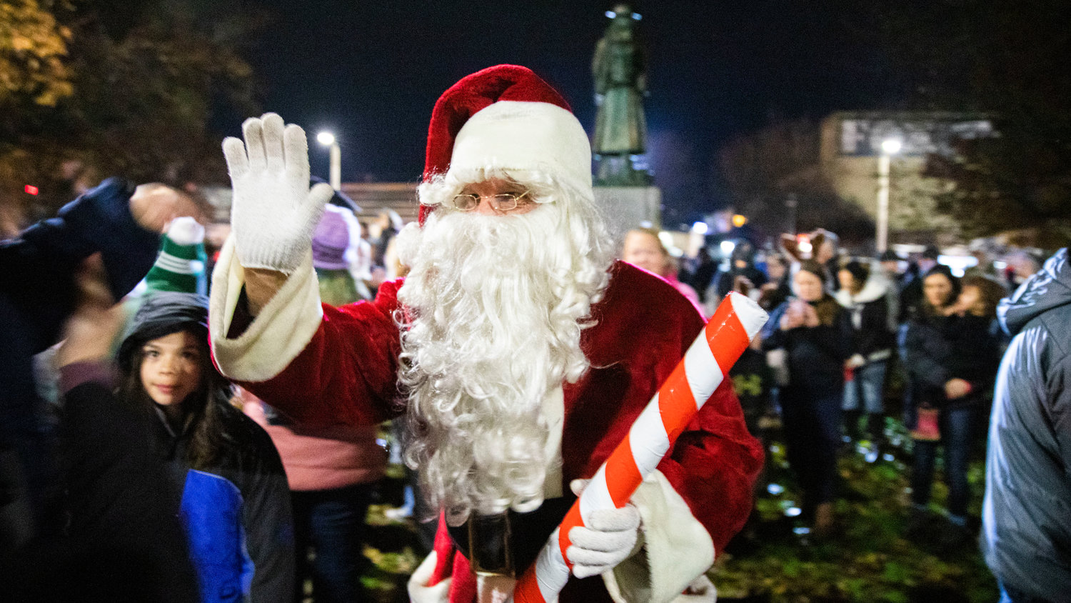 Santa high-fives visitors at George Washington Park before a Christmas Tree Lighting celebration.
