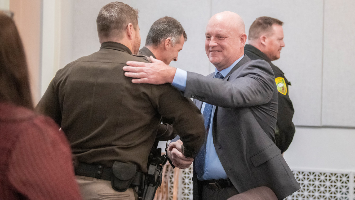 Scott Brummer smiles and greets deputies after being sworn in as the Lewis County District 3 commissioner Wednesday morning in Chehalis.