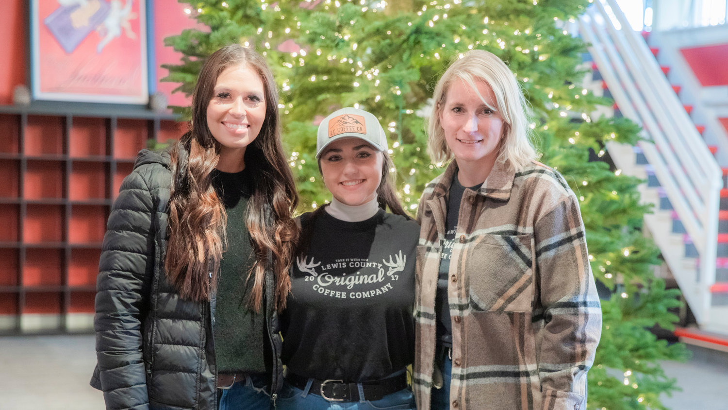 From left, Angie Twining, Cheyenne Sanford and Sam Magnuson with Lewis County Coffee Co. smile for a photo at The Station in Centralia Wednesday morning.