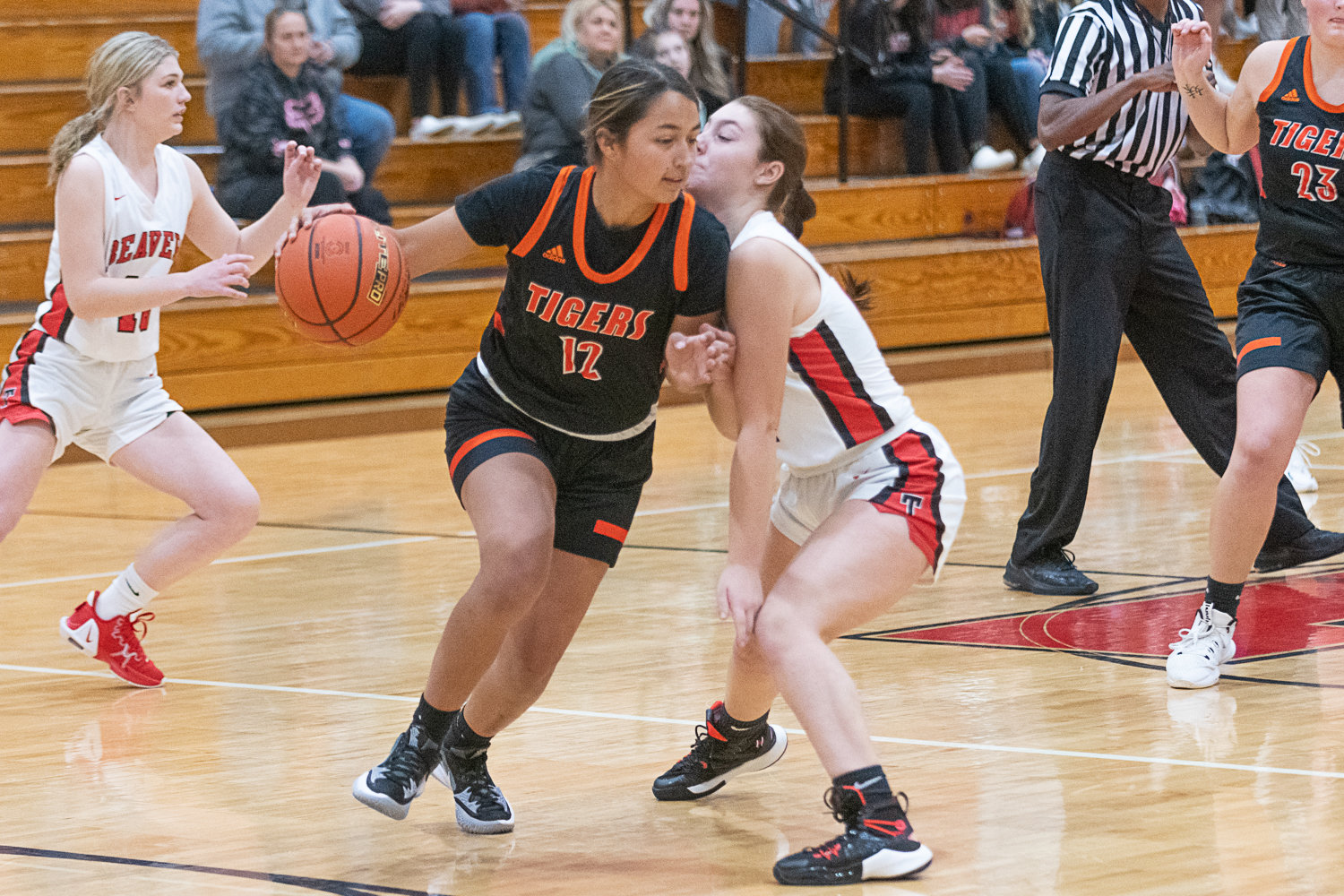 Centralia's Makayla Chavez dribbles around contact during the first quarter of the Tigers' 56-16 win at Tenino to open the season on Dec. 1.