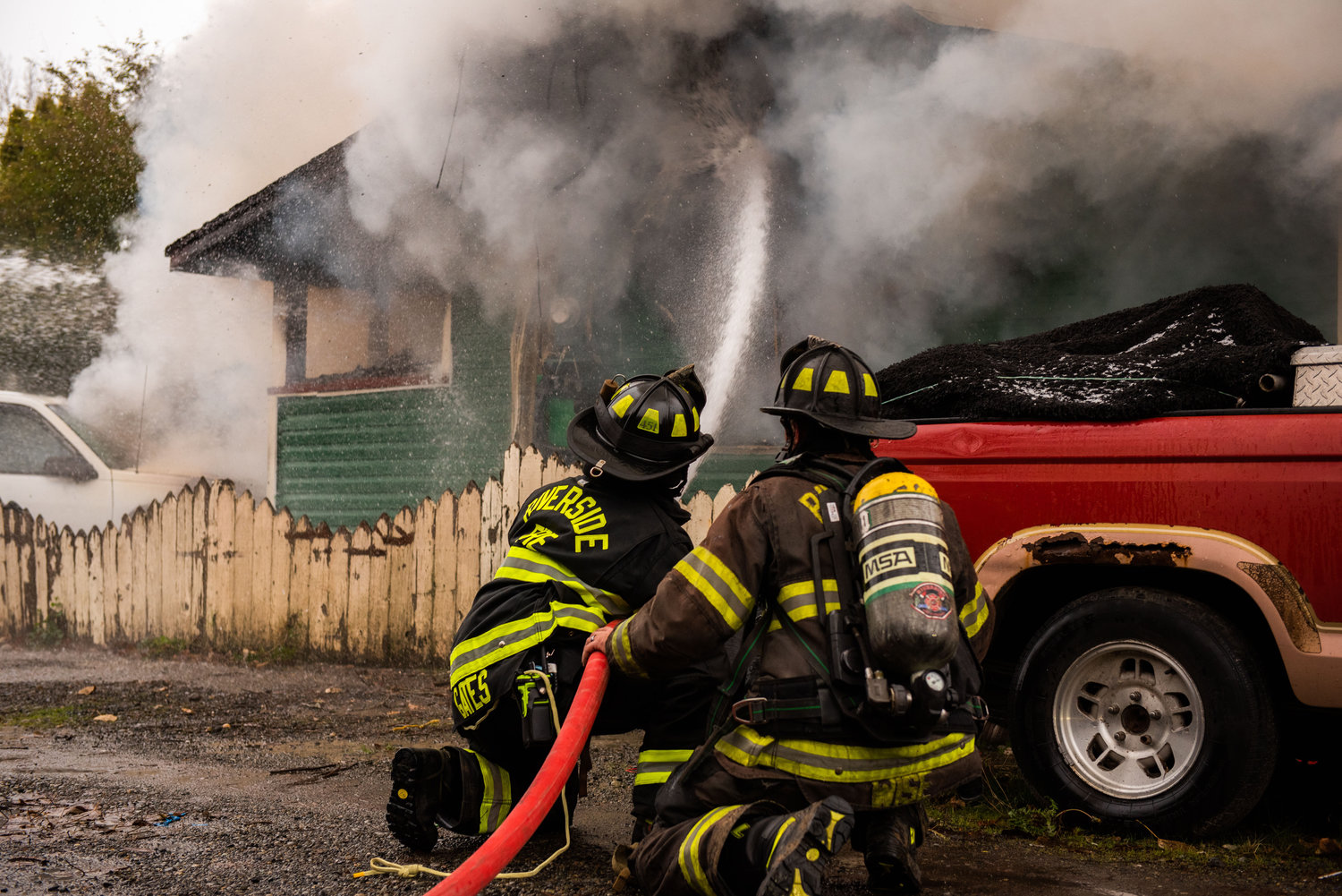 Riverside firefighters work to put out flames in a building off W. Main Street in Centralia on Sunday.