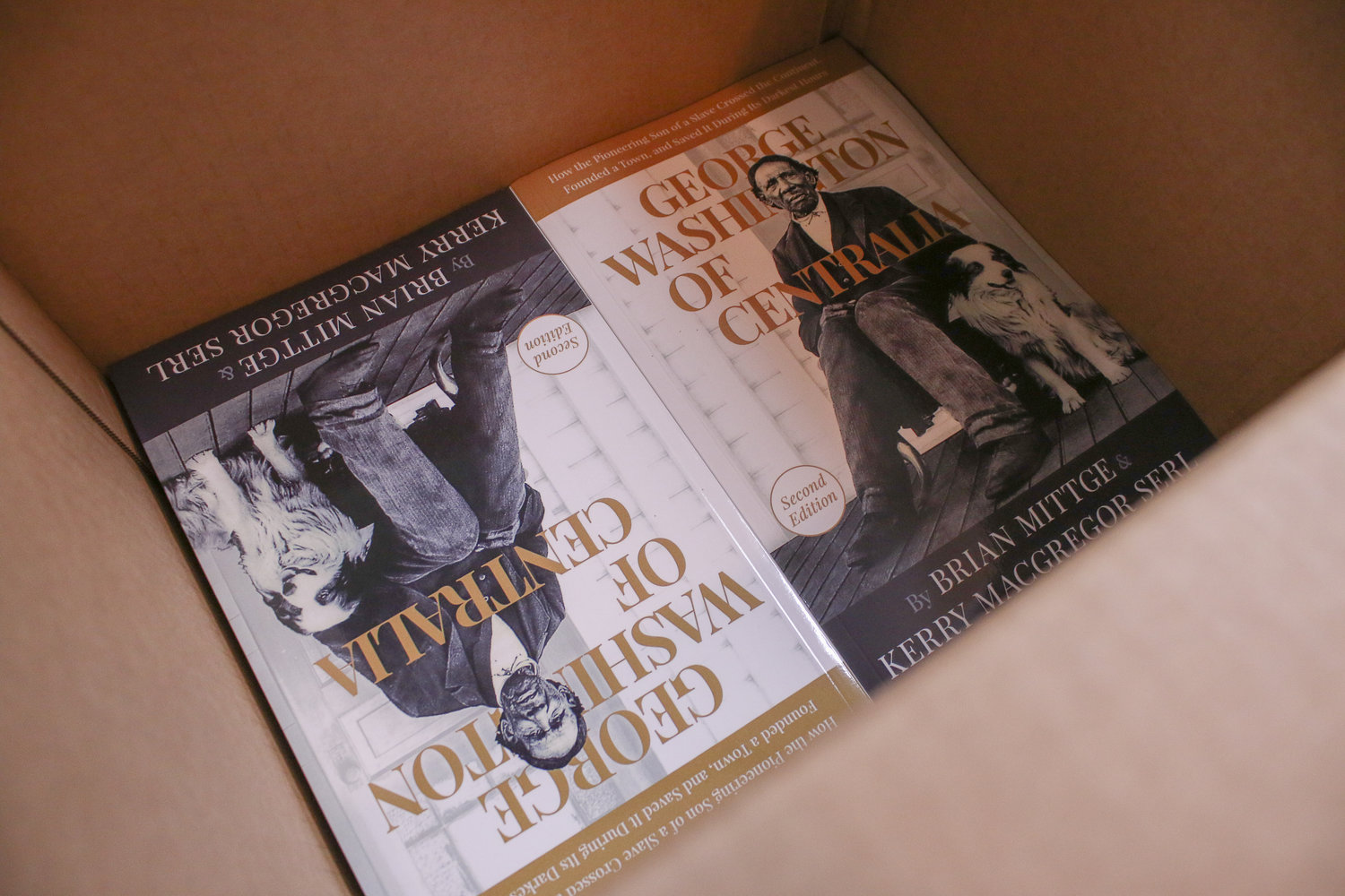Copies of the second edition of George Washington of Centralia by Brian Mittge and Kerry Serl sit in a box waiting to be dropped off at local book stores.