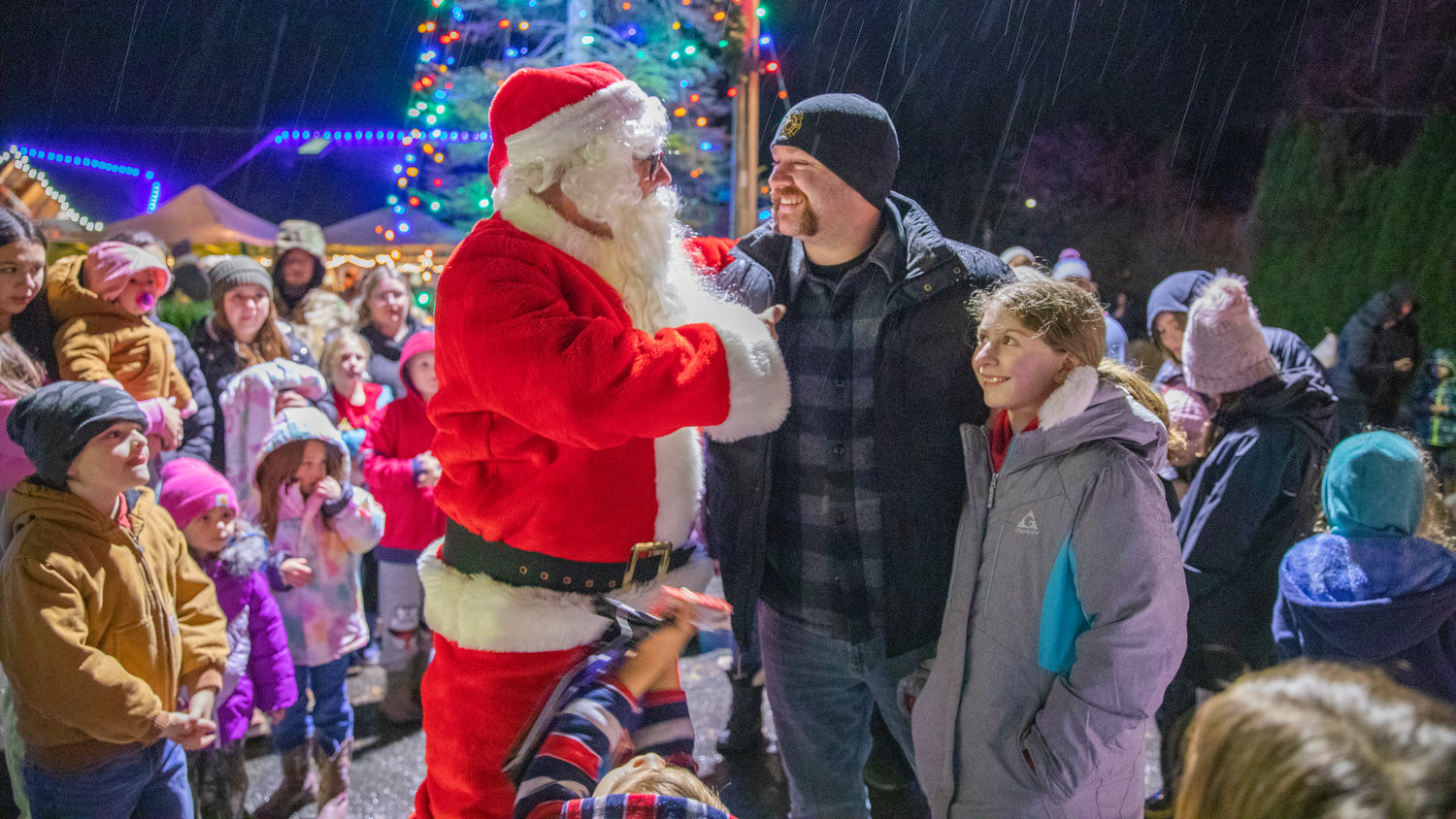 Mayor Wayne Fournier smiles for a photo with family and Santa Friday night during the downtown Tenino Christmas tree lighting.