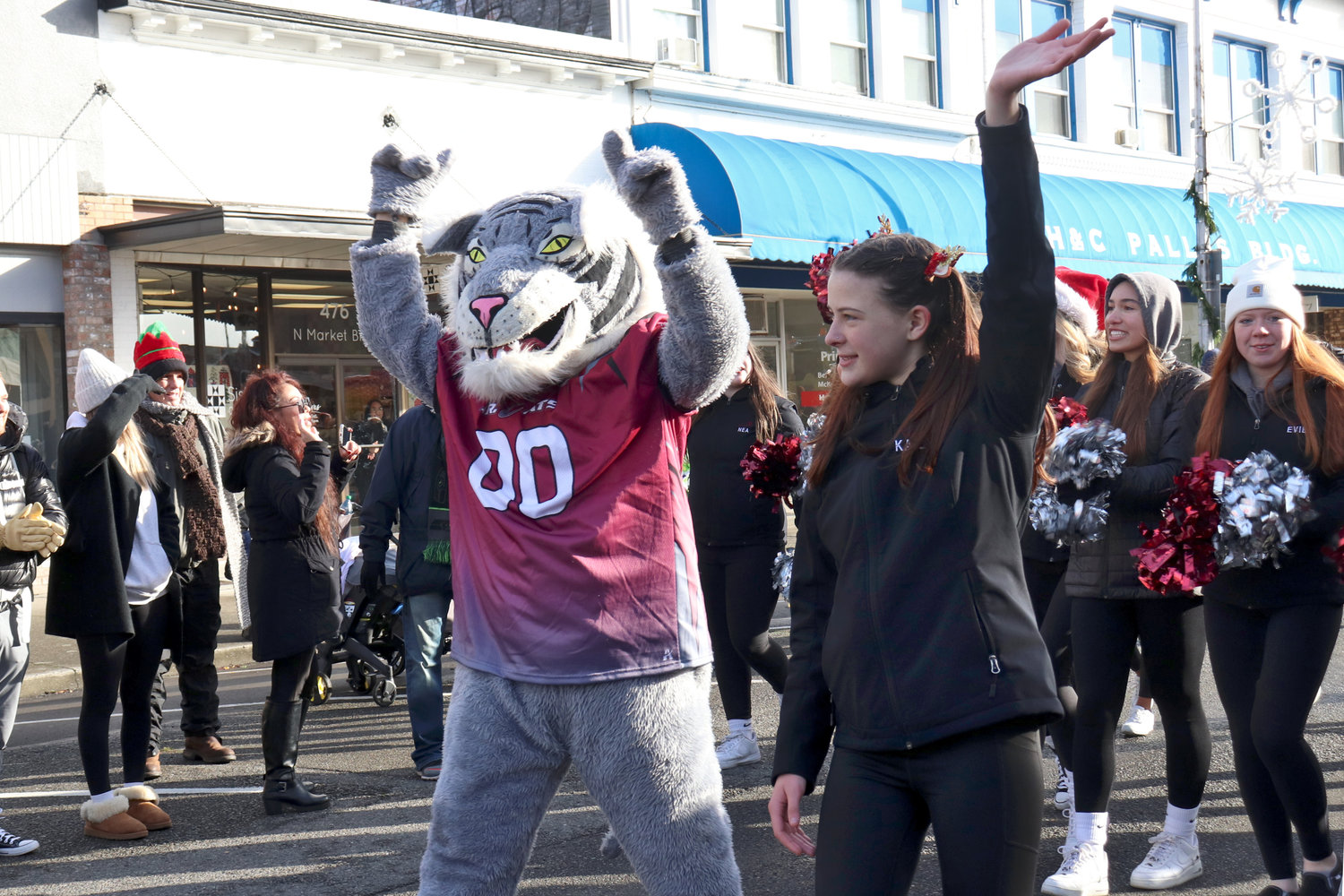 The W.F. West High School Bearcat walks alongside cheerleaders during the Santa Parade in downtown Chehalis on Saturday.