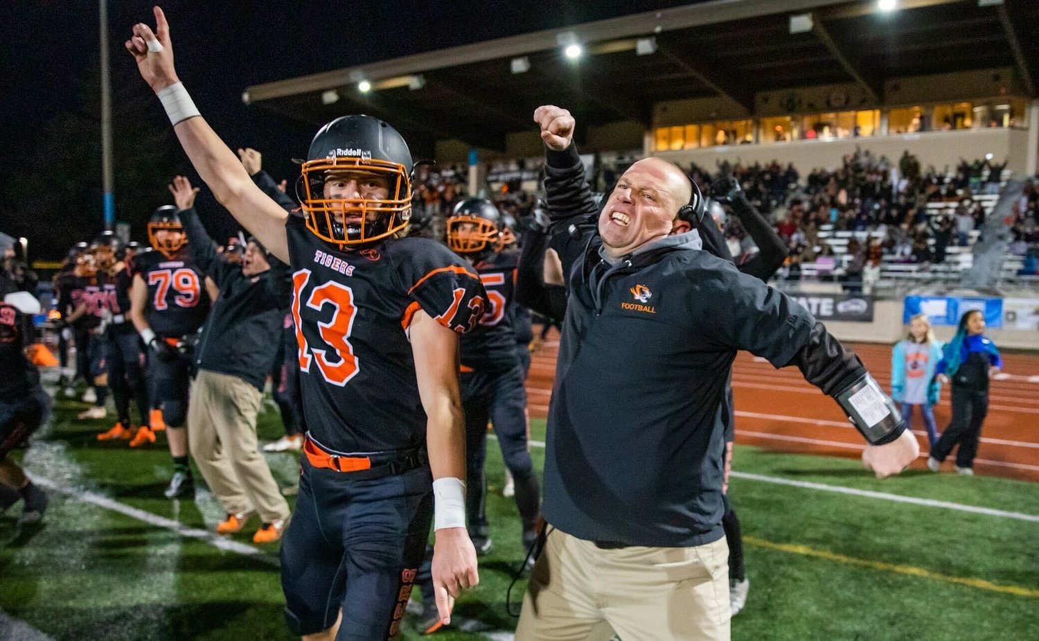 Napavine athletes and coaches celebrate Saturday night at Harry E. Lang Stadium in Lakewood during a 2B State Championship game against Okanogan.