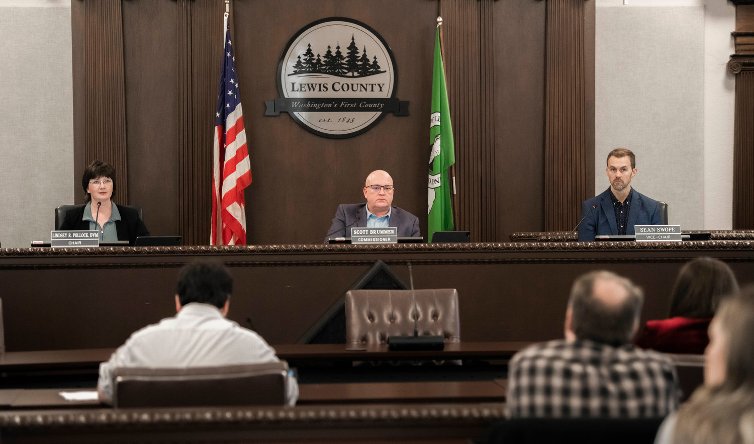FILE PHOTO — Lewis County Commissioners Lindsey Pollock, Scott Brummer and Sean Swope prepare to pass resolutions during a November 2022 meeting.
