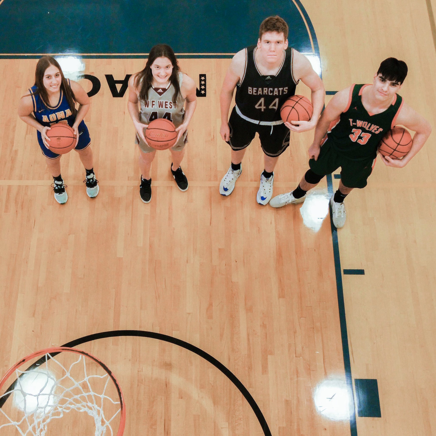 From left, Adna’s Karlee VonMoos, W.F. West’s Julia and Soren Dalan, and MWP’s Josh Salguero hold basketballs and pose for a photo in the Centralia College gymnasium on Tuesday.