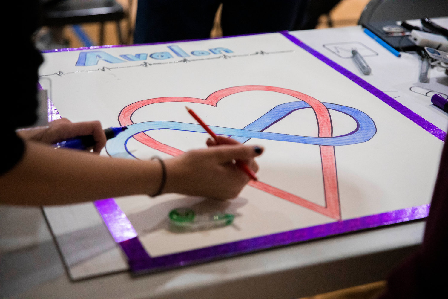 Centralia High School students draw logos for their company during Washington Business Week at the Northwest Sports Hub on Wednesday.