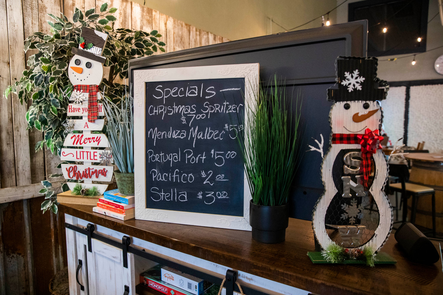 Drink specials sit on display between two snowmen at the Luxe Wine Bar located at 207 N. Tower Avenue in Centralia.
