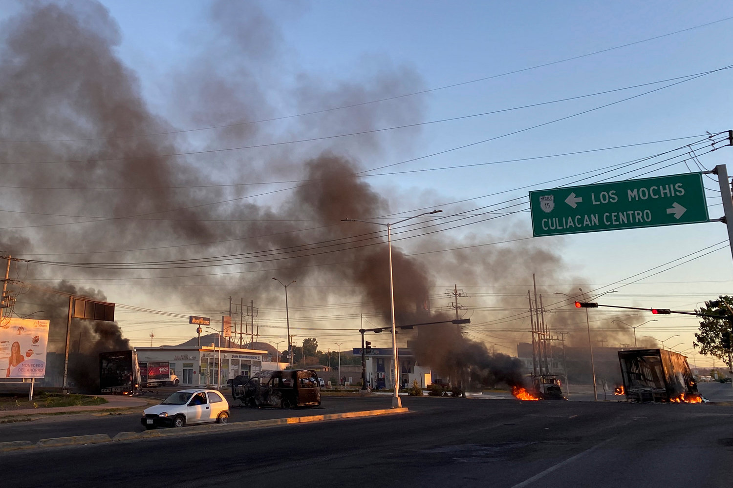 Burning vehicles are seen in the street during an operation to arrest the son of Joaquin "El Chapo" Guzman, Ovidio Guzman, in Culiacan, Sinaloa state, Mexico, on Thursday, Jan. 5, 2023. (Marcos Vizcarra/AFP/Getty Images/TNS)