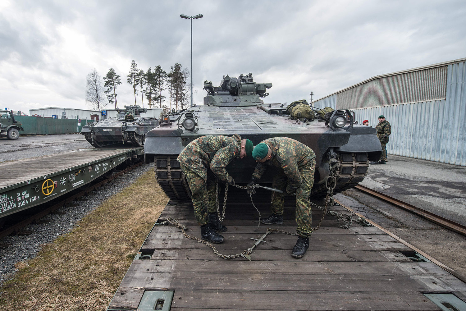 German soldiers load armored vehicles of the type "Marder" on a train at the troop exercise area in Grafenwoehr, southern Germany, on Feb. 21, 2017. (Armin Weigel/DPA/AFP via Getty Images/TNS)