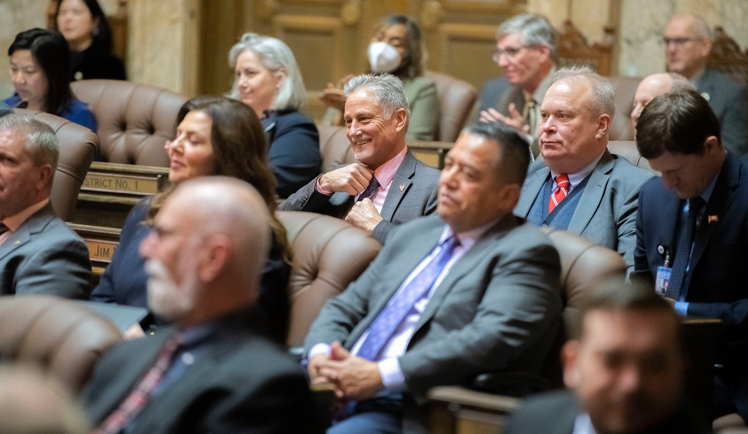 Senator Jeff Wilson smiles while attending Gov. Jay Inslee’s 2023 State of the State speech alongside State Rep. Jim Walsh  in early January.