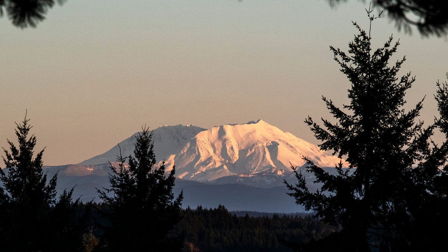 Mount St. Helens glows in blues and whites near sunset in this photo captured west of Chehalis Sunday.