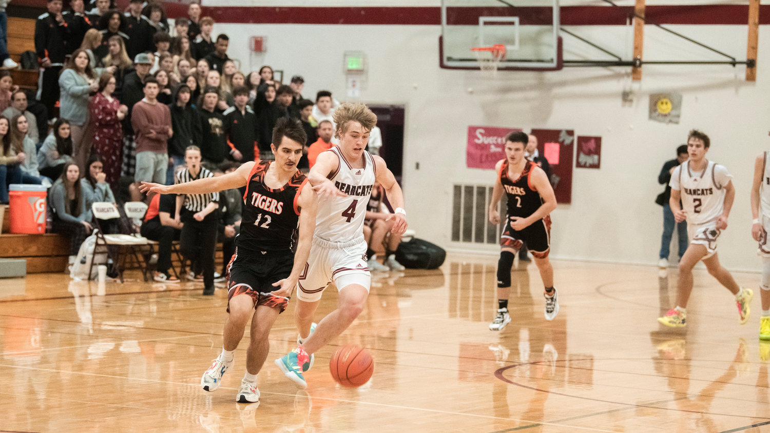 Centralia senior Darrell Neuert (12) and W.F. West sophomore Gage Brumfield (4) scramble for a loose ball during a Tuesday night game in Chehalis.