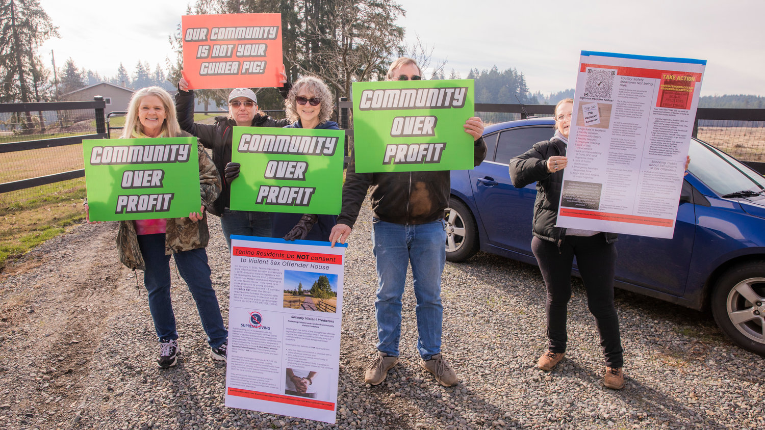 From left, Kathy Taylor, Suzanne Brown, Rachelle Reinitz, a neighbor who brought extra signs and wished to stay anonymous, and Kim Crist who lives across the street, gather for a demonstration outside the Supreme Living facility located at 2813 140th Avenue Southwest in Tenino on Wednesday.