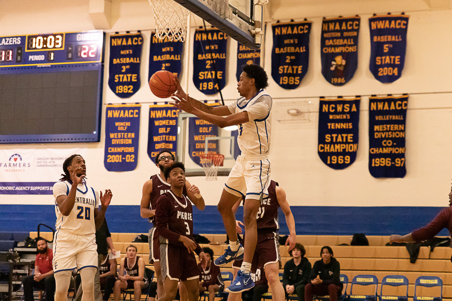 Centralia College guard Adrian Brown makes a pass underneath the hoop for a layup against Pierce at Michael Smith Gym Feb. 1.