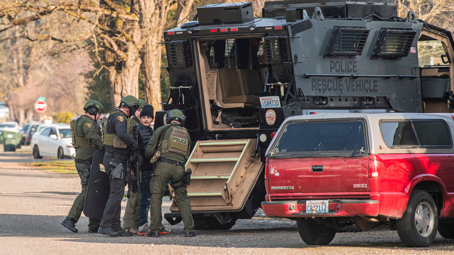 Law enforcement works to detain an individual in the 1300 block of Windsor Avenue in Centralia on Thursday.
