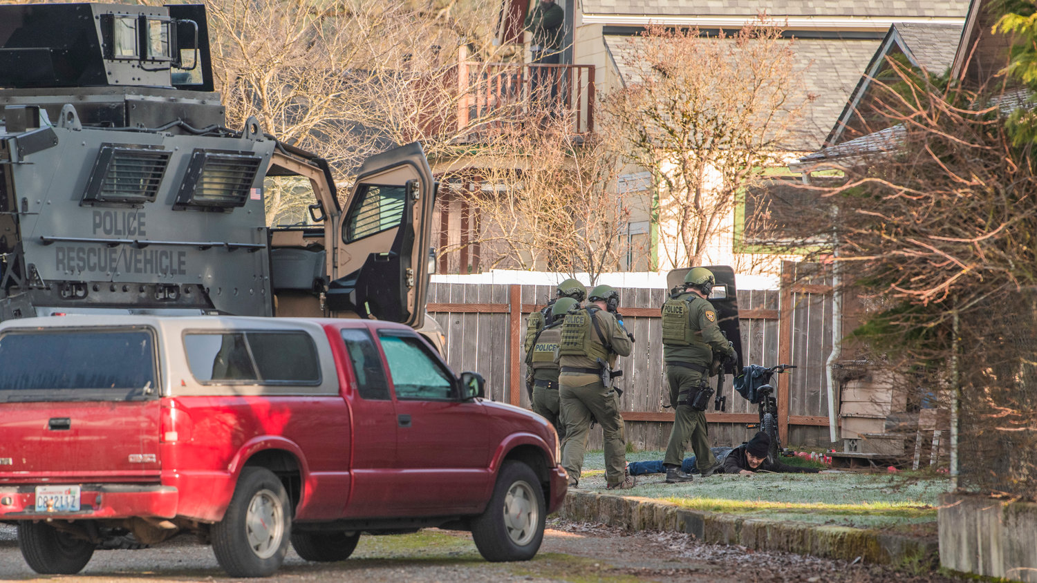 Law enforcement works to detain an individual in the 1300 block of Windsor Avenue in Centralia on Thursday.