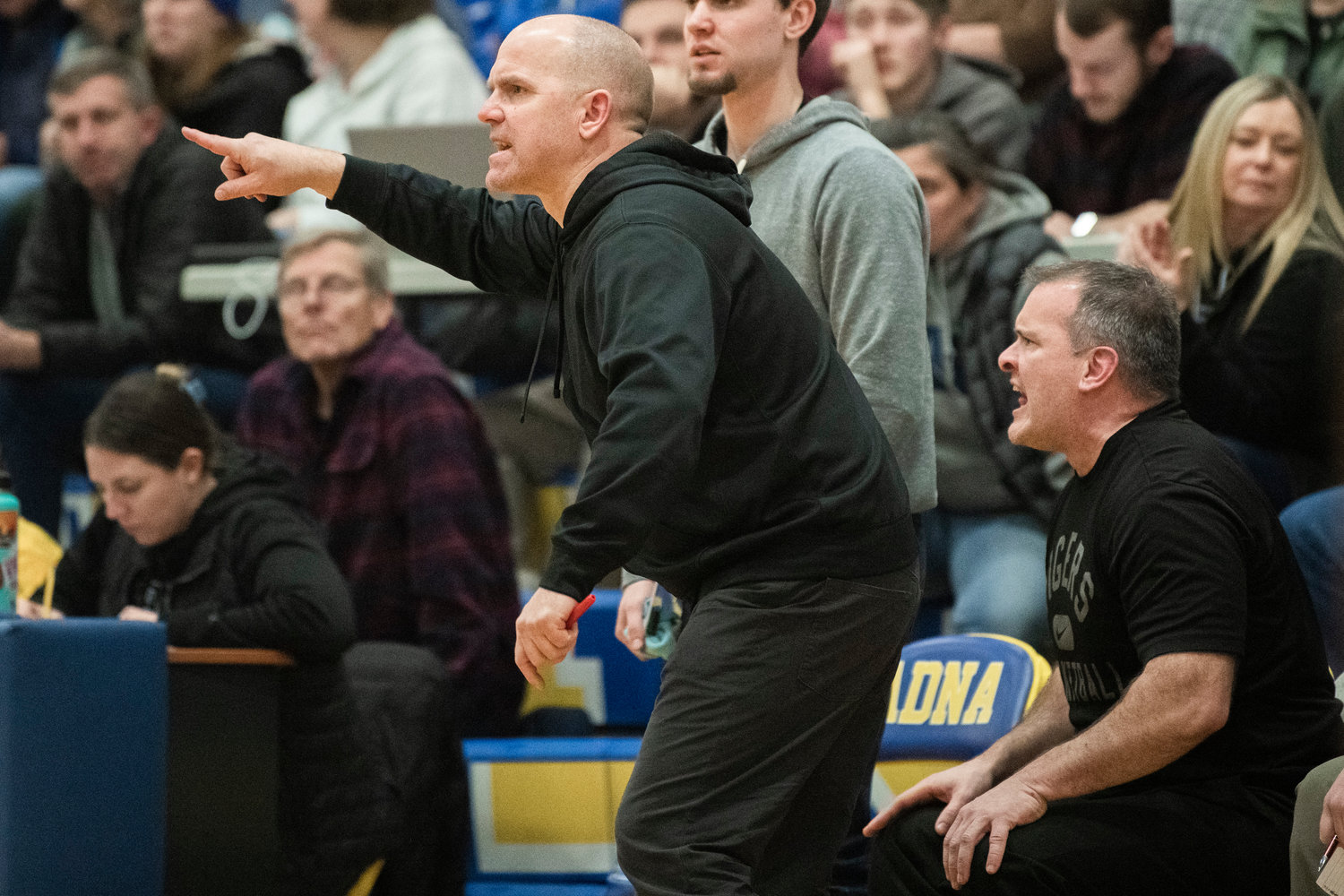 Napavine Head Coach Rex Stanley yells to athletes on the court during a game against Adna on Thursday.