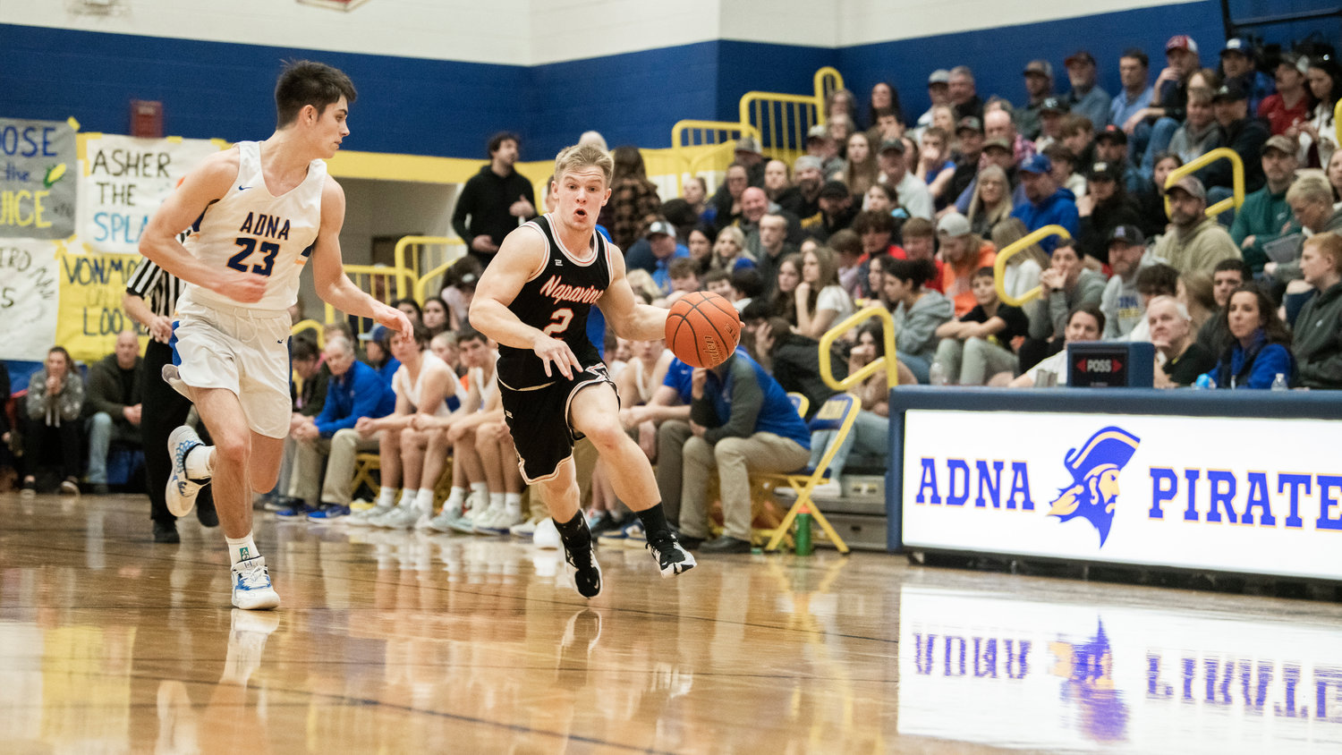 Napavine junior Cael Stanley (2) dribbles toward the hoop during a game against Adna on Thursday.