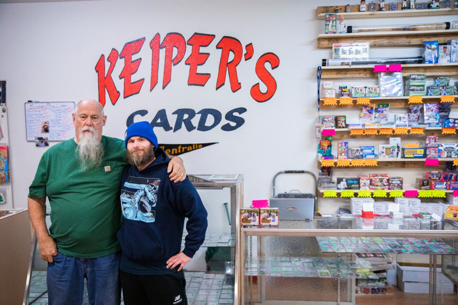 FILE PHOTO — Charlie Redmon and Dan Keiper pose for a photo inside Keiper’s Cards in downtown Centralia last year.