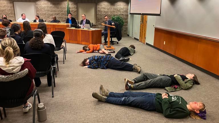 Members of the Thurston Youth Climate Coalition staged a die-in Thursday at Lacey City Council, wanting to protest the lack of local action to fight climate change