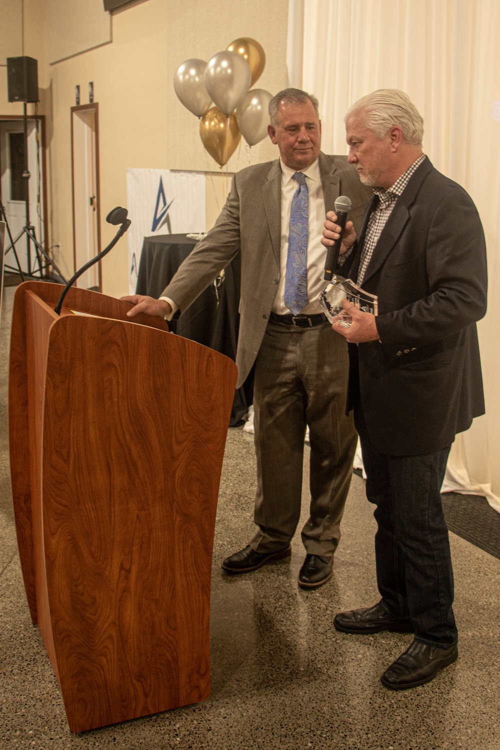 Port of Chehalis commissioner Paul Ericson recieves the Gail & Carolyn Shaw Industry award during the Economic Alliance of Lewis County's 40th annual banquet at Jesters Auto Museum on Friday night.