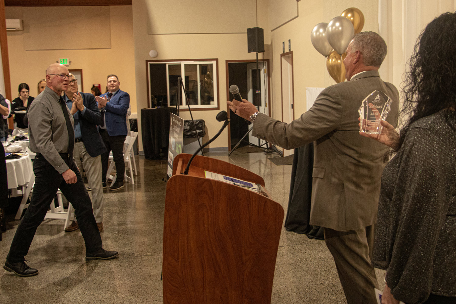Centralia City Manager Rob Hill steps up to accept the Economic Alliance of Lewis County's staff award at the alliance's 40th annual banquet Friday night.