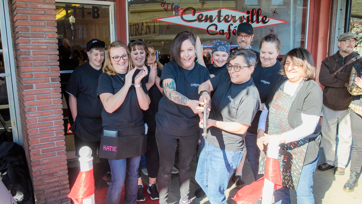 Lisa and Michelle Little smile as a ribbon is cut outside The Centerville Cafe in Centralia on Wednesday during an event hosted by the Centralia-Chehalis Chamber of Commerce. The Centerville Cafe reopened Jan. 5 with new owners Michelle and Lisa Little in downtown Centralia. The cafe is located at 111 N. Tower Ave. in Centralia. Both Michelle and Lisa Little grew up in the area and have been going to The Centerville Cafe for over 20 years. Before being approached by the previous owners, Marion Manzer and Morris Gall, about purchasing the restaurant, Michelle Little managed a restaurant in Olympia, and Lisa Little worked as a nurse. Manzer and Gall wanted the restaurant to stay family owned to maintain the spirit of The Centerville Cafe in Centralia. According to the chamber, the cafe got its name in 2013 when Manzer and Gall bought what had been called the “Jersey Diner” and renamed it after the original name of Centralia, which was Centerville. The Centerville Cafe — under various names — is more than 120 years old.
“We focus on having really good food, cooked with love. We want it to feel like home when you come in. Our staff really makes this place amazing,” Michelle Little said.