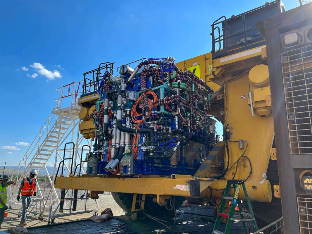 Workers retrofit a new hydrogen fuel cell powerplant onto an ultra-class haul truck at the Anglo American's Mogalakwena platinum mine in South Africa for the proof-of-concept truck that was tested there in May 2022.