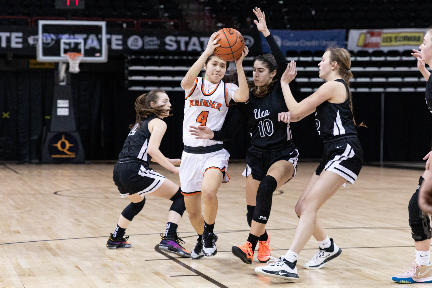 Rainier guard Angelica Askey drives through the lane against Upper Columbia Academy March 1 in the 2B state tournament round of 12 at Spokane Arena.