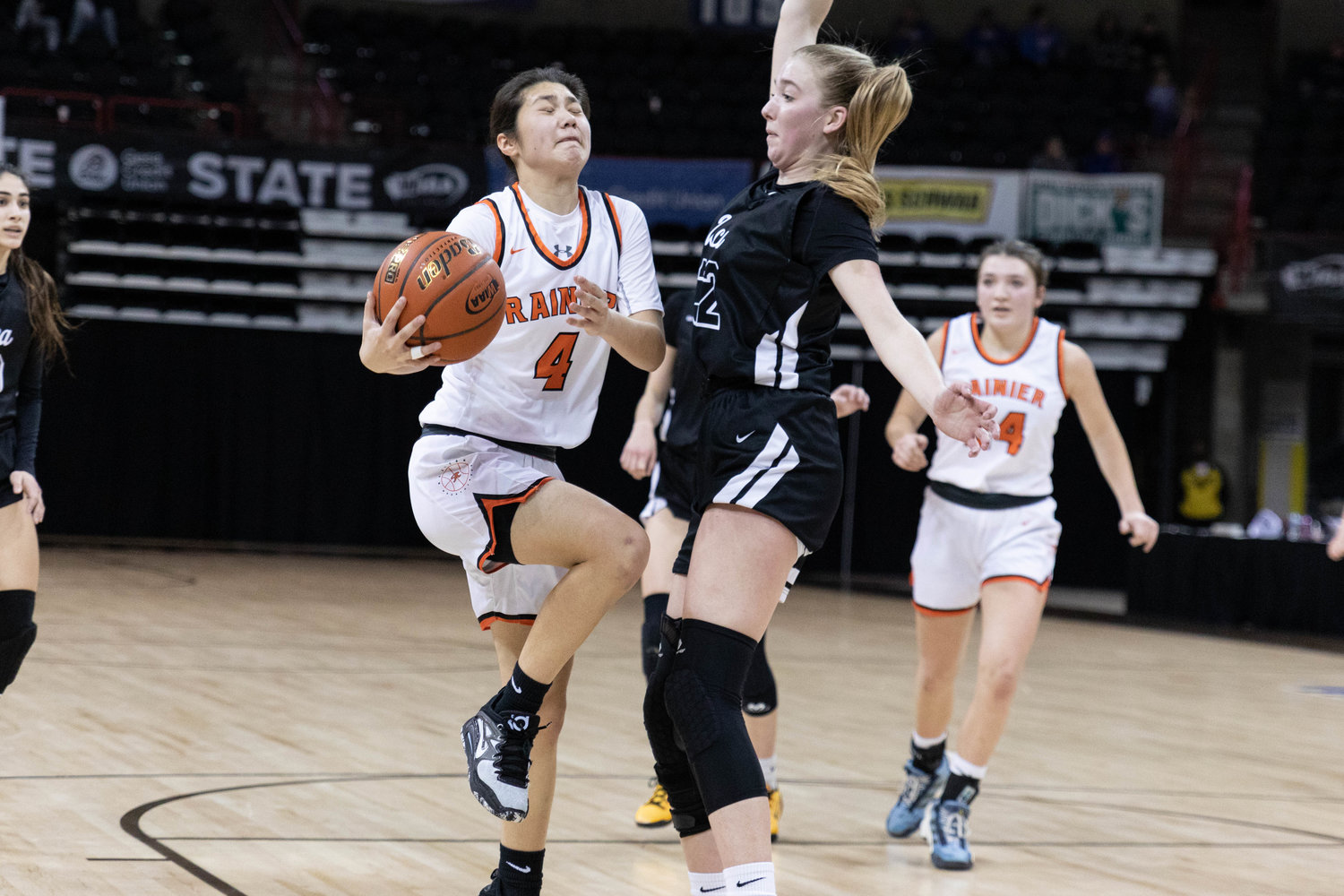 Rainier guard Angelica Askey slices through the lane against Upper Columbia Academy March 1 in the 2B state tournament round of 12 at Spokane Arena.