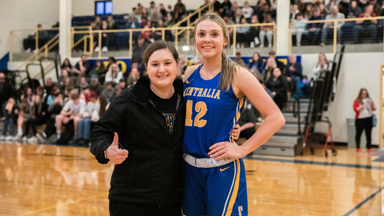 Tumwater’s Kylie Waltermeyer poses for a photo with Tiffany Twiddy after taking first place in a three-point competition during a Southwest Washington High School All-Star game at Centralia College Friday night.