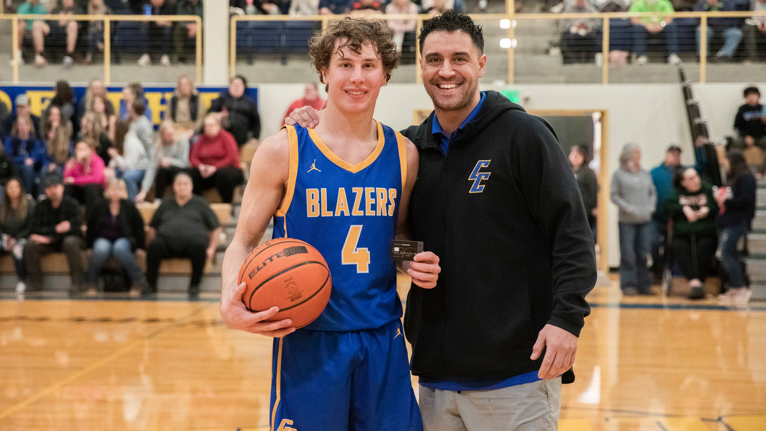 Tumwater’s Luke Brewer poses for a photo with Joe Chirhart after taking first place in a three-point competition during a Southwest Washington High School All-Star game at Centralia College Friday night.