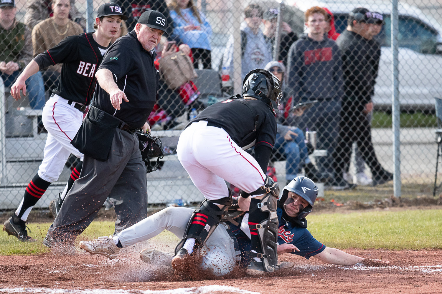 Tenino catcher Austin Gonia gets a tag down on Black Hills' Alec Lynch during the Beavers' 7-4 win over the Wolves on March 14.