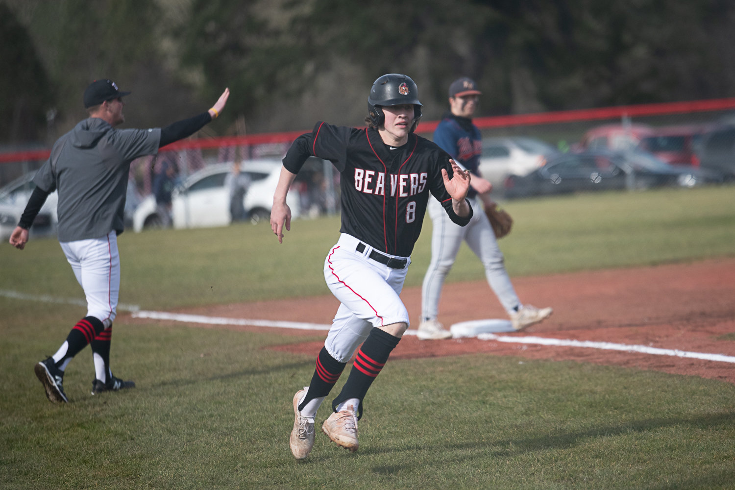 Kellan Knox rounds third and heads for home to score during Tenino's 7-4 win over Black Hills on March 14.