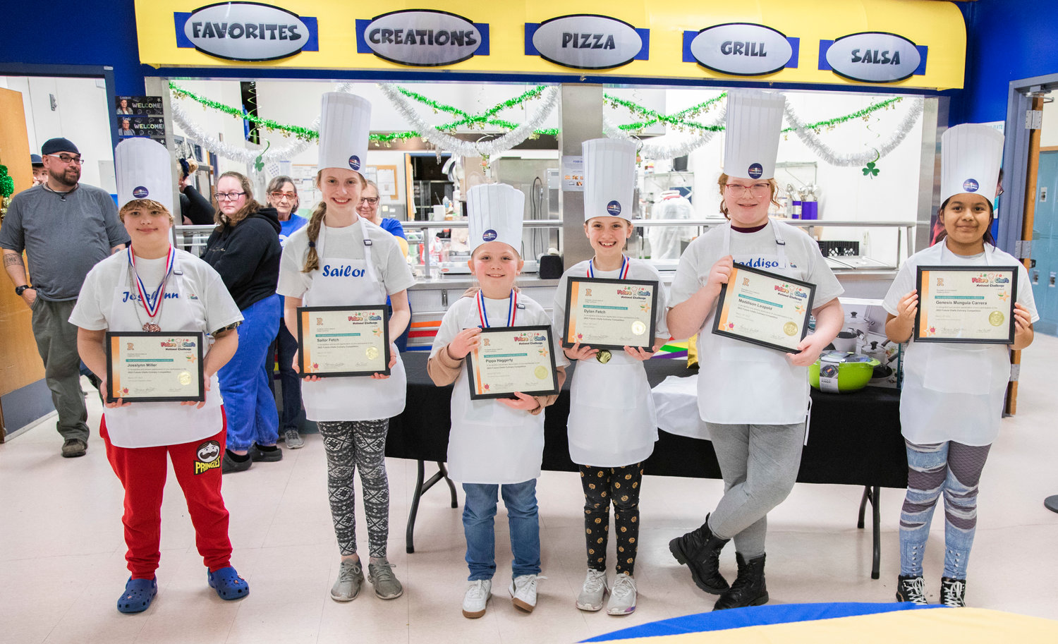 From left, Grand Mound Elementary students Josslynn Miller, Sailor Fetch, Pippa Haggerty, Dylan Fetch, Maddison Leopold and Genesis Mungia Carrera pose for a photo with certificates after completing the Future Chefs National Competition at Rochester High School on Thursday.