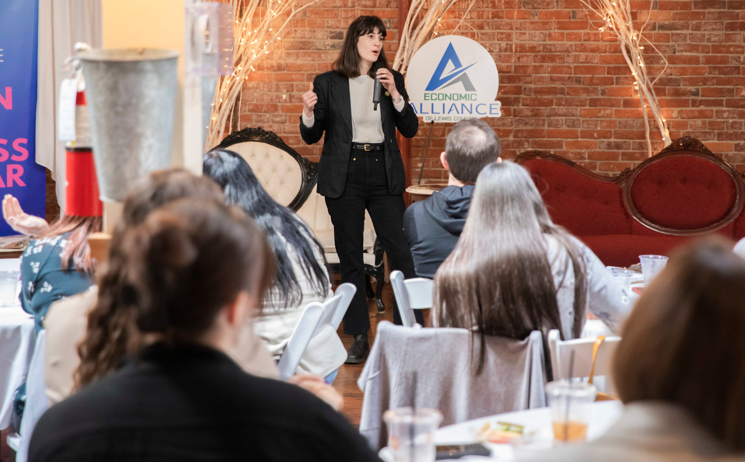 Congresswoman Marie Gluesenkamp Perez talks at attendees during a Women in Business Seminar inside the Vintage Grand Room at the Washington Hotel in Chehalis.