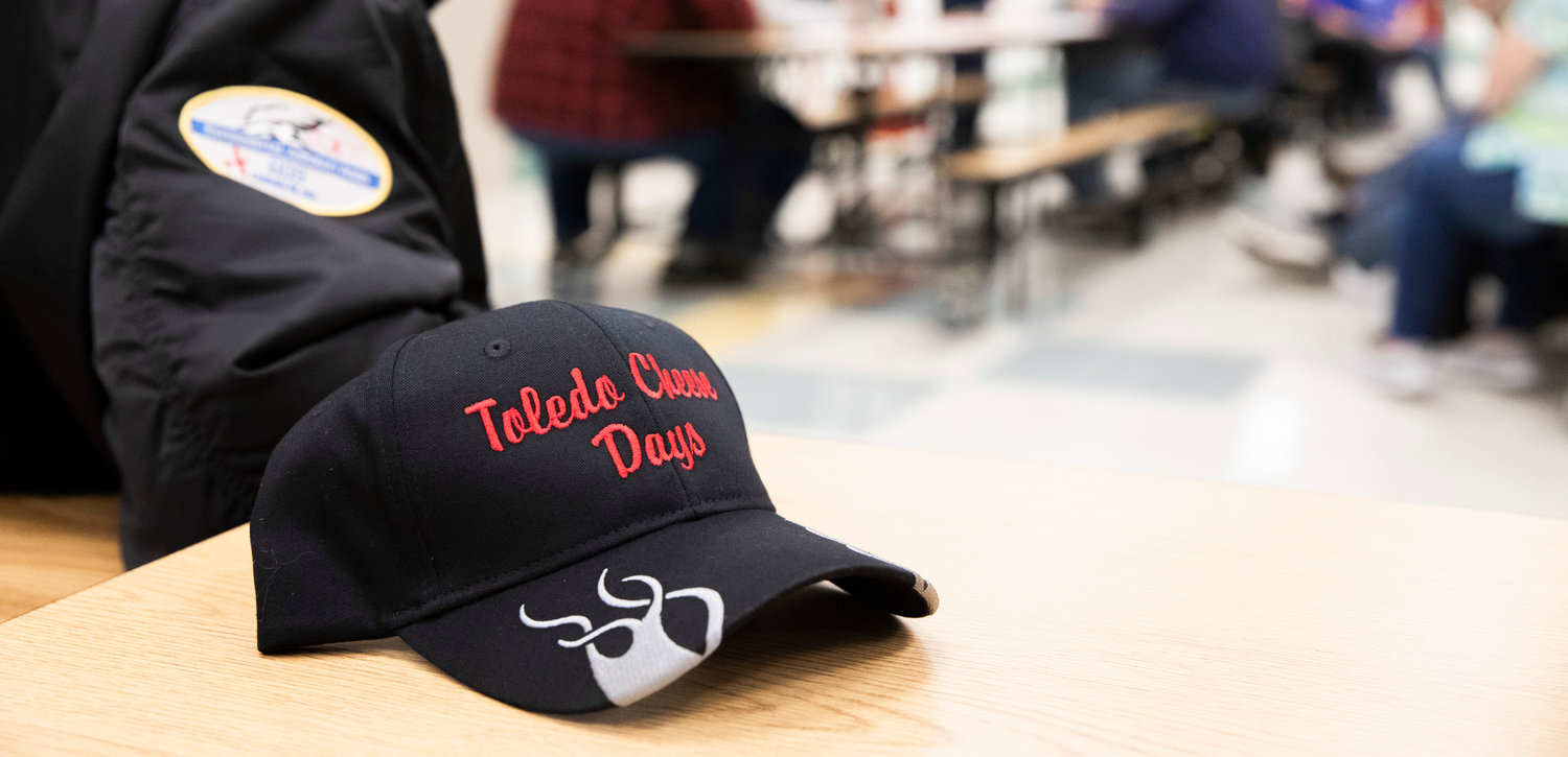 A Toledo Cheese Days cap sits on a table after being flung into the crowd during the Big Toledo Community Meeting on Thursday.