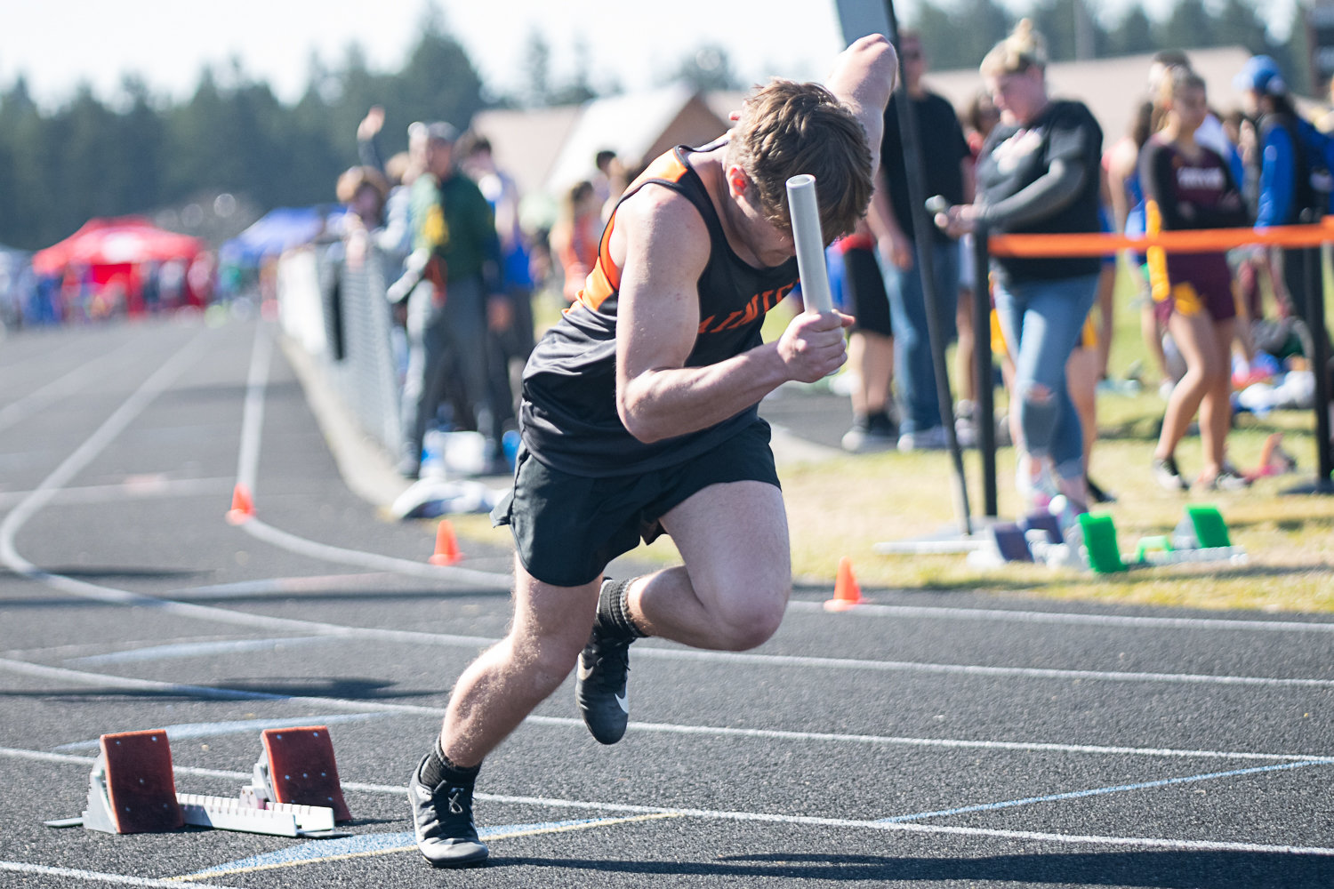 Chris Grey gets out of the blocks to start the 4x100 relay for Rainier at the Rainier Icebreaker on March 18.