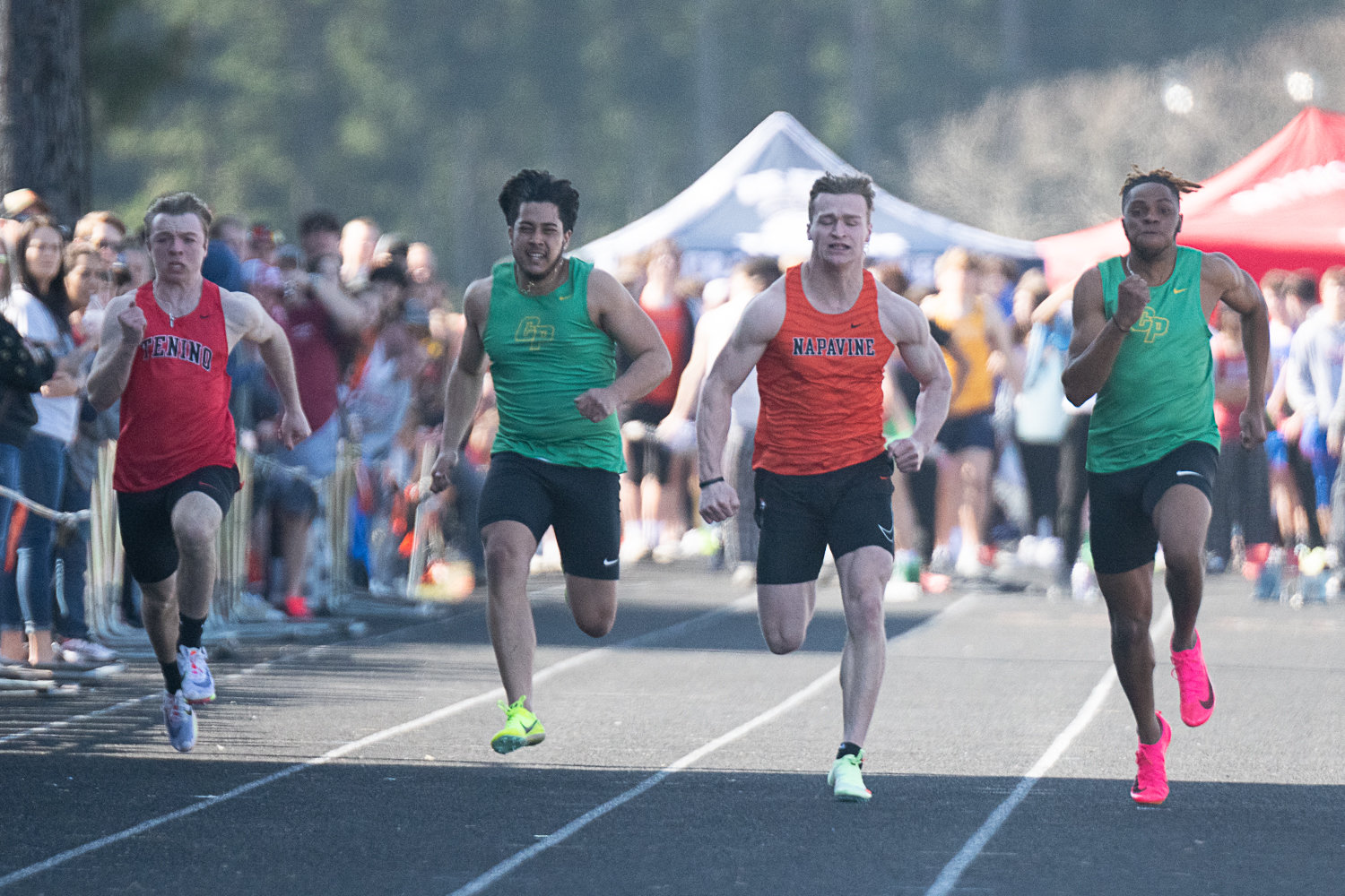 Tenino's Blaine Schott (left) and Napavine's Max O'Neill (second from right) run the 100-meter dash at the Rainier Icebreaker on March 18.