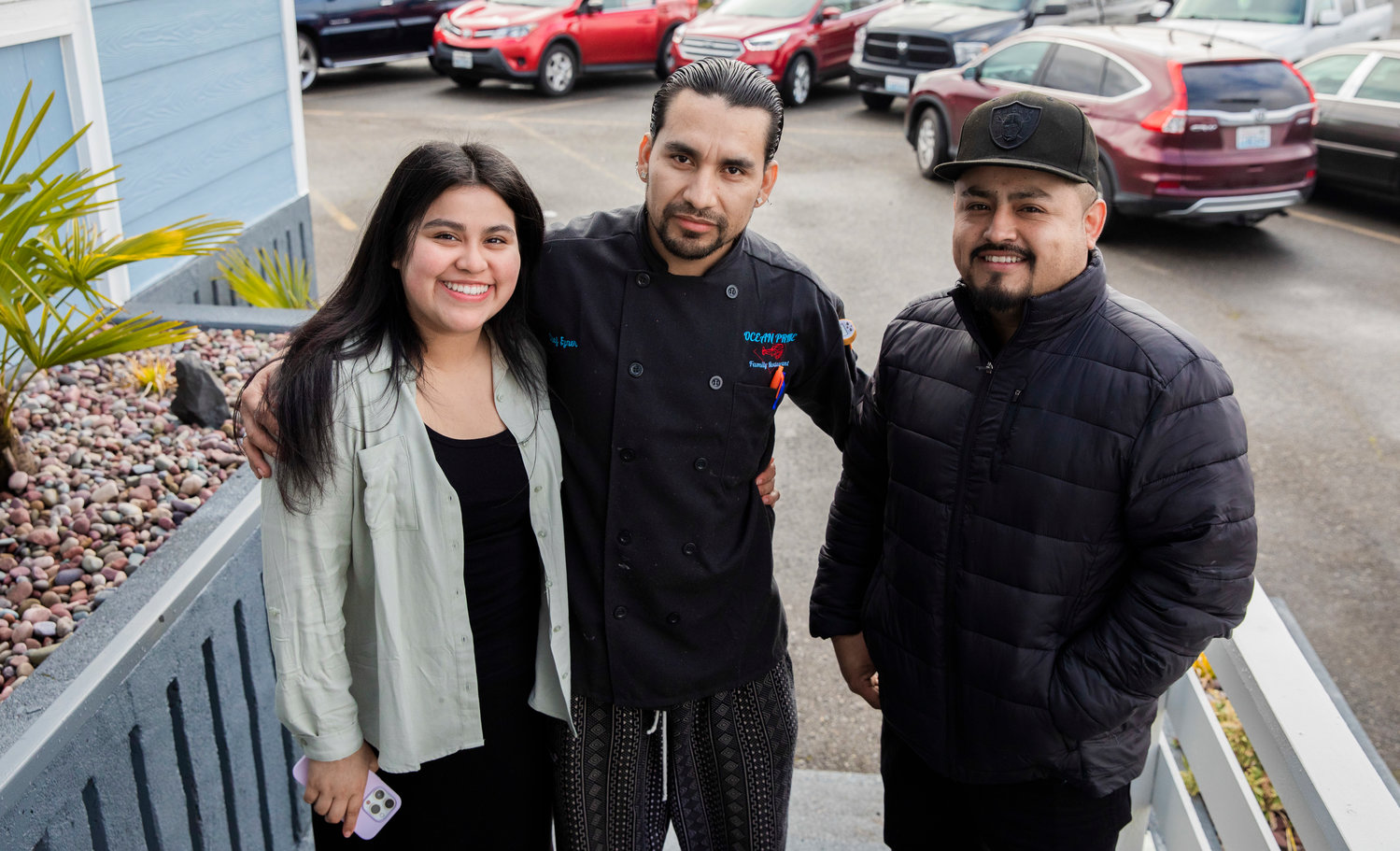 Chef Eyner "Rene" Cardona poses for a photo with attendees at a grand opening ceremony Monday morning outside Ocean Prime Family Restaurant in Chehalis.