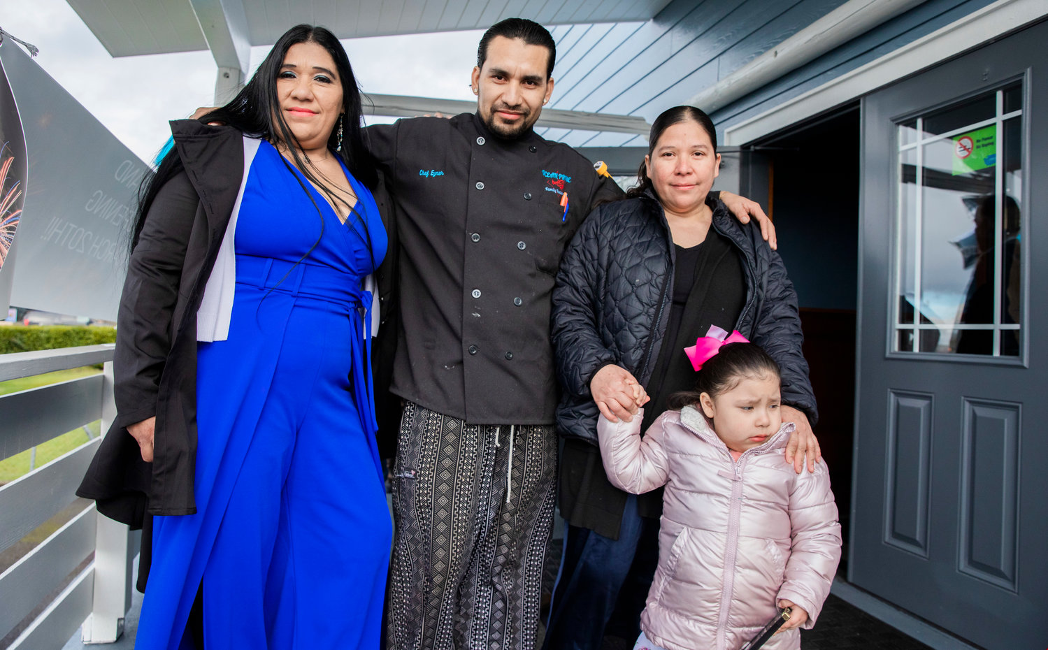 Chef Eyner "Rene" Cardona poses for a photo with attendees at a grand opening ceremony Monday morning outside Ocean Prime Family Restaurant in Chehalis.