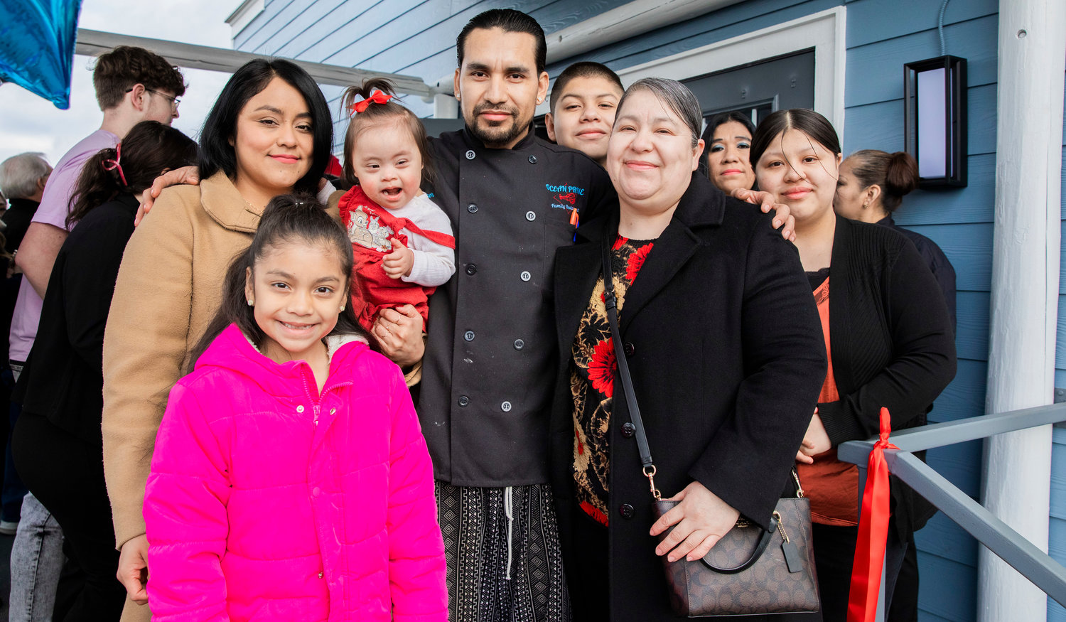 Chef Eyner "Rene" Cardona poses for a photo with family during a grand opening ceremony Monday morning outside Ocean Prime Family Restaurant in Chehalis.