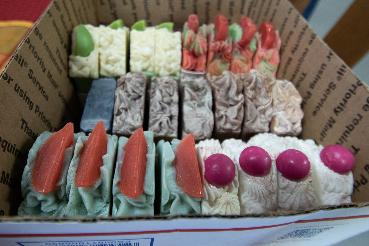 Handmade soaps by Salina Binion of Cosmic Secret Soapery sit in a box as she restocked her inventory at Toledo Treasures. These soaps are just one among a number of items made by local artisans for sale at the newly opened Toledo Treasures thrift store.