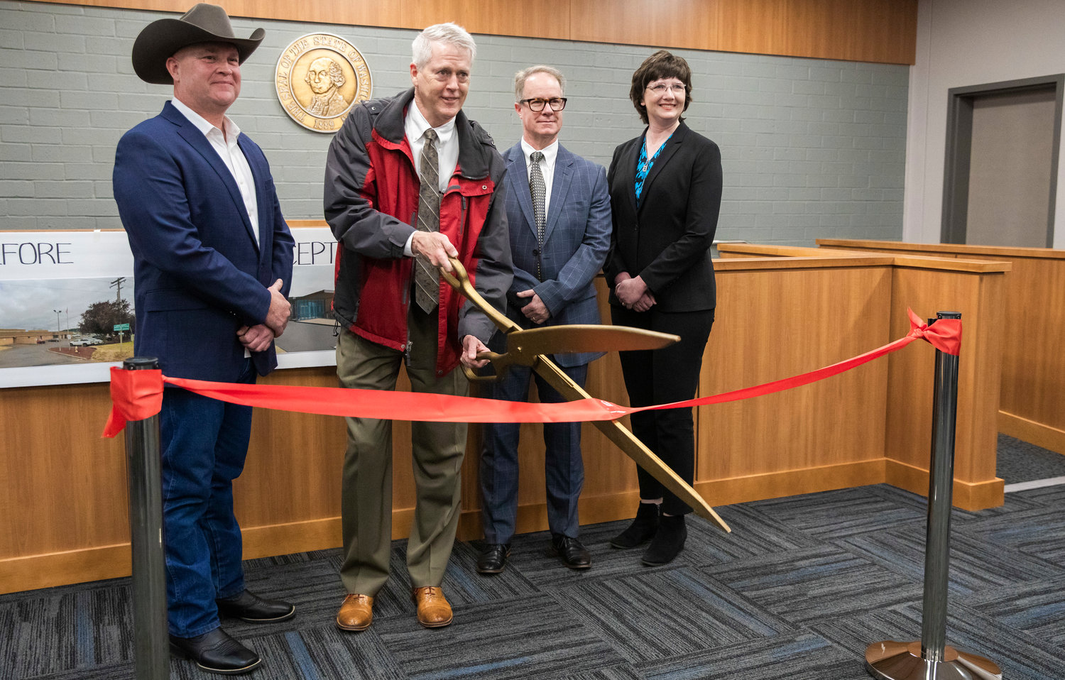 From left, Commissioner Scott Brummer, Judge James W. Lawler, Judge J. Andrew Toynbee and Commissioner Lindsey Pollock smile for a photo during a ribbon cutting ceremony at the Lewis County Juvenile Justice Center in Chehalis Friday morning.
