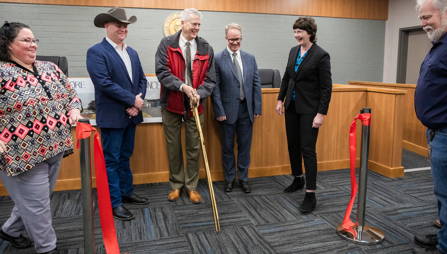 From left, Commissioner Scott Brummer, Judge James W. Lawler, Judge J. Andrew Toynbee and Commissioner Lindsey Pollock smile after a ribbon cutting ceremony at the Lewis County Juvenile Justice Center in Chehalis Friday morning.