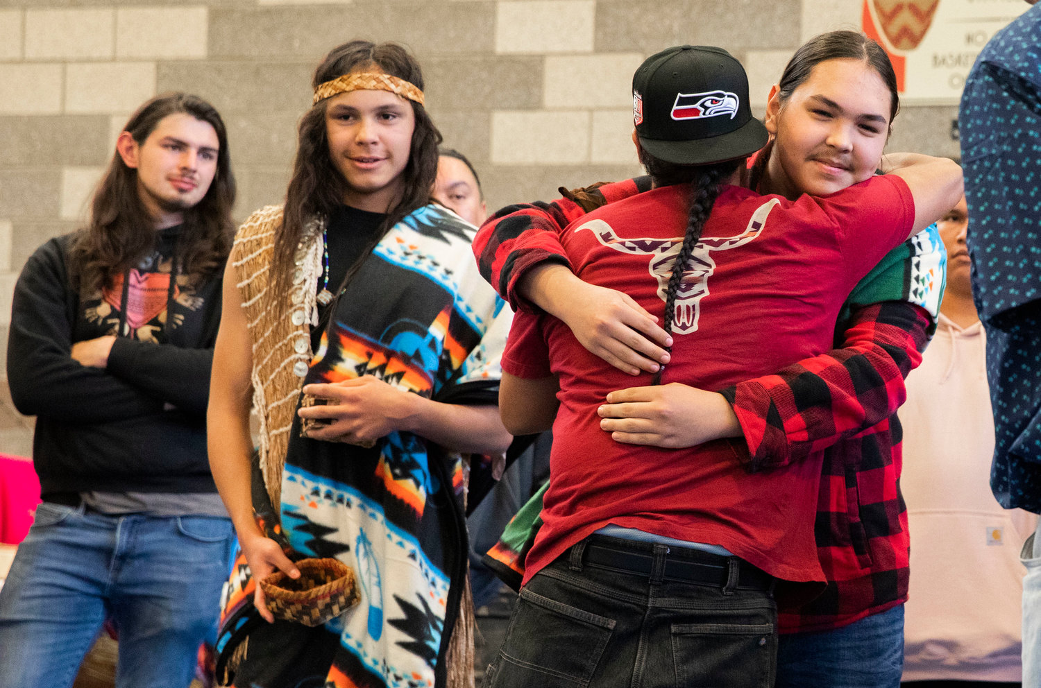 “Junior,” or Aholagana Komakhuk, receives an embrace during a ceremony honoring the Hazel Pete legacy alongside his brother “William” or Agugaluk Komakhuk at the Chehalis Tribe Community Center in Oakville on Saturday.
